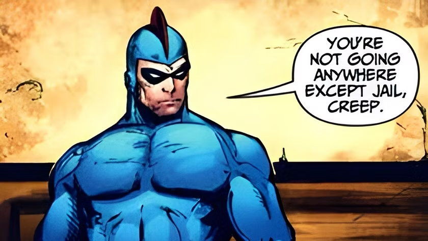 Blue Beetle, acompañado de una viñeta de texto que dice "You're not going anywere except jail, creep"